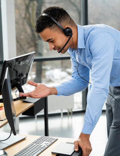 SAP support engineer assisting at computer.